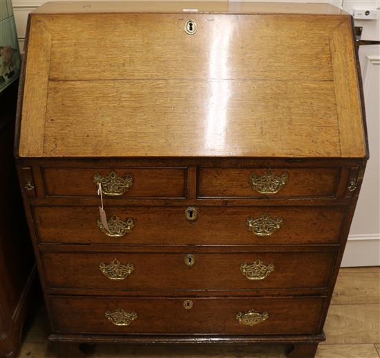 A George III oak bureau, W.91cm